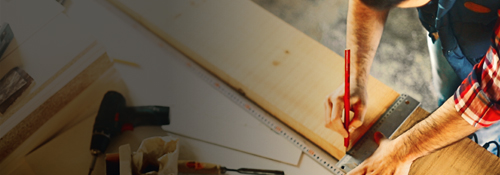 A carpenter measuring table on a construction site